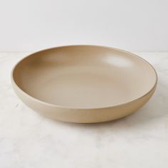 a white bowl sitting on top of a marble counter