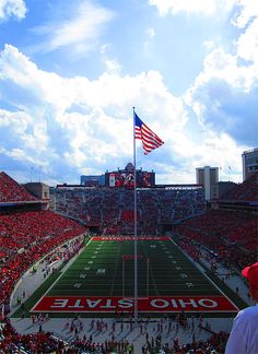 a stadium filled with people and an american flag