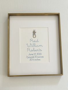 a wedding ring is displayed in a frame