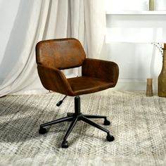 an office chair sitting on top of a carpeted floor next to a vase and window