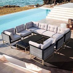 an outdoor patio furniture set next to a swimming pool