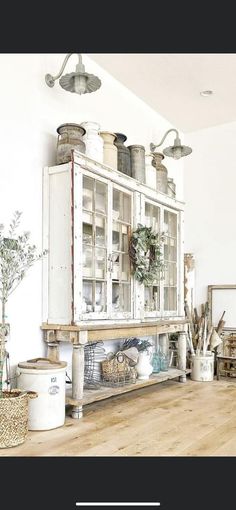 a white cabinet sitting on top of a wooden floor