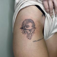 a woman with a tattoo on her thigh