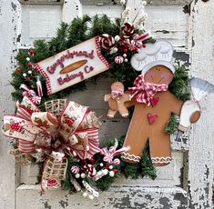 a wreath decorated with gingerbreads and candy canes