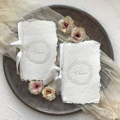 three pieces of paper on a plate with flowers