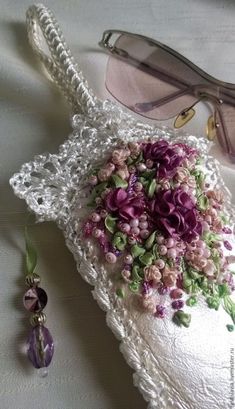 a pair of glasses sitting on top of a white doily