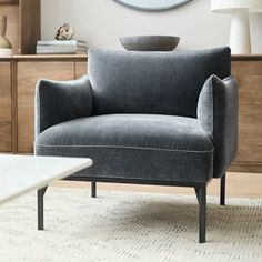 a living room scene with focus on the arm chair and coffee table in the foreground