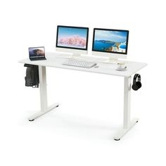 two computer monitors sitting on top of a white desk