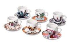 six coffee cups and saucers with designs on them