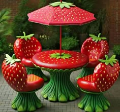 an outdoor table and chairs made to look like strawberries with umbrellas on top