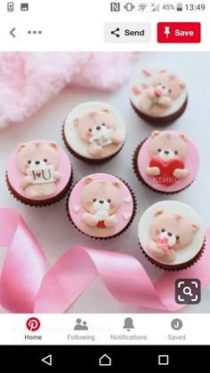 some cupcakes with teddy bears on them and pink ribbon next to each other