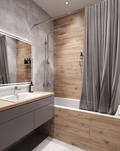 a bathroom with a tub, sink and shower curtained in grey drapes next to the bathtub