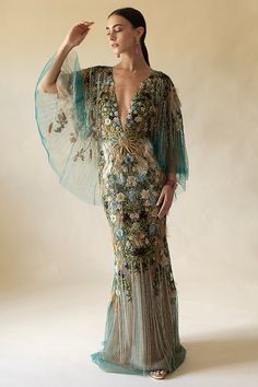 Marchesa mesh v-neck gown in peacock. 92% Silk, 8% Elastic, Lining: 100% Nylon Dry Clean Only Made in USA Luxury V-neck Gown For Gala, Luxury V-neck Gala Gown, Glamorous Silk V-neck Gown, Glamorous Green V-neck Gown, Luxury Spring V-neck Evening Dress, Spring Silk Gown With V-neck, Spring Silk V-neck Gown, Luxury V-neck Cocktail Gown, Marchesa Couture