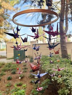 a group of origami birds hanging from a tree