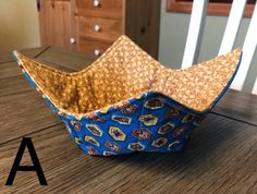 a paper basket sitting on top of a wooden table