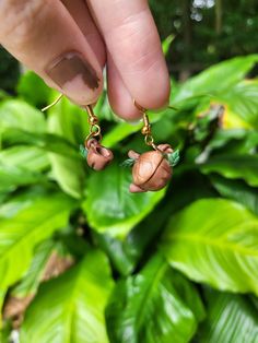 A pair of handmade earrings with two acorns, one is shaped into a teapot and the other a tea cup. The kind of tea set fairies might use. Tea Cup Earrings, Fairy Earrings, Cute Sets, Ear Wire, Daughter Love, Handmade Earrings, Tea Set, Tea Cup, Beautiful Earrings