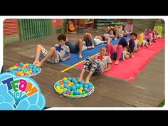 several children laying on the ground with toys in front of them and an advertisement for toy world