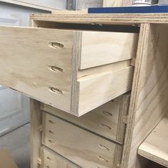 an unfinished dresser with drawers is shown in the process of being assembled