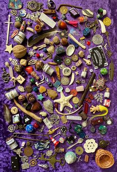 a pile of assorted items sitting on top of a purple blanket next to each other