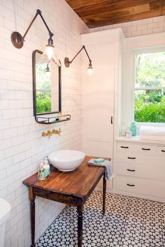 a bathroom with a sink, mirror and window