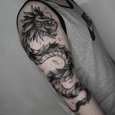 a man with a dragon tattoo on his arm