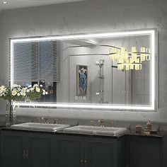 a bathroom with two sinks and a large mirror