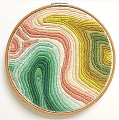 an embroidery project with multicolored lines on it