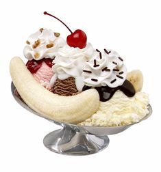 an ice cream sundae with banana split and cherries on top, in a silver dish