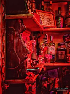 a shelf filled with lots of liquor bottles and assorted items on top of it