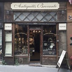 an old fashion store front with glass windows