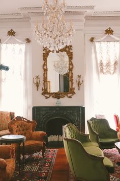 a living room filled with furniture and a chandelier