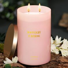 a pink candle sitting on top of a wooden table