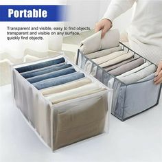 the portable storage box is open and filled with folded clothes