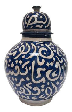 a blue and white vase with arabic calligraphy on it's lid, isolated against a white background