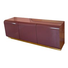 a large purple cabinet with three doors and gold trimmings on the bottom, in front of a white background