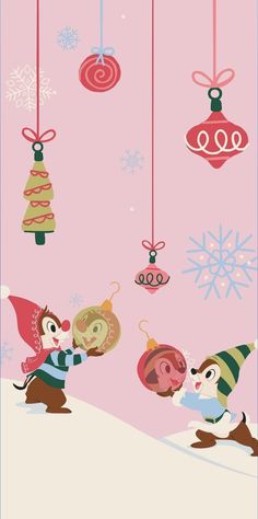 two cartoon characters are playing in the snow with christmas ornaments hanging from strings above them