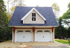 two garages in front of a wooded area