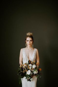 a woman holding a bouquet of flowers in her hands