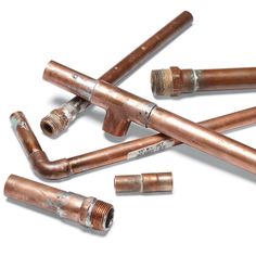 several copper colored pipes laying next to each other on a white surface with the words handyman written below them