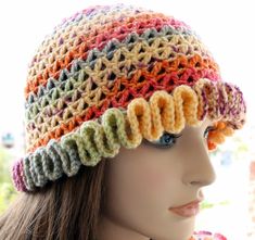 a mannequin head wearing a multicolored crocheted hat