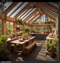 a room filled with lots of potted plants and wooden tables in front of windows