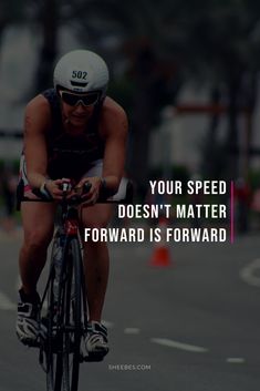 a woman riding a bike down a street with a quote on the front saying your speed doesn't matter forward is forward