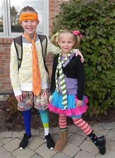 two young children dressed in costumes standing next to each other