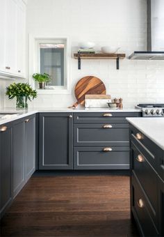 a kitchen with gray cabinets and white walls