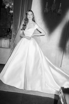 a black and white photo of a woman in a wedding dress with the words coming soon eli