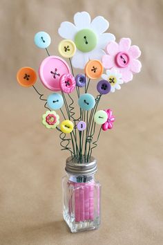 a mason jar filled with buttons and flowers