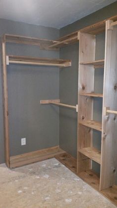 an empty room with wooden shelves in it