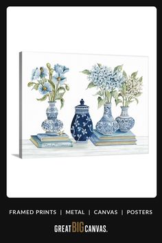 three blue and white vases with flowers in them sitting on a shelf next to each other