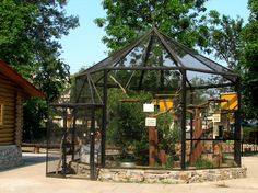 an outdoor area with a gazebo and trees in the background