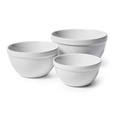 three white bowls sitting next to each other